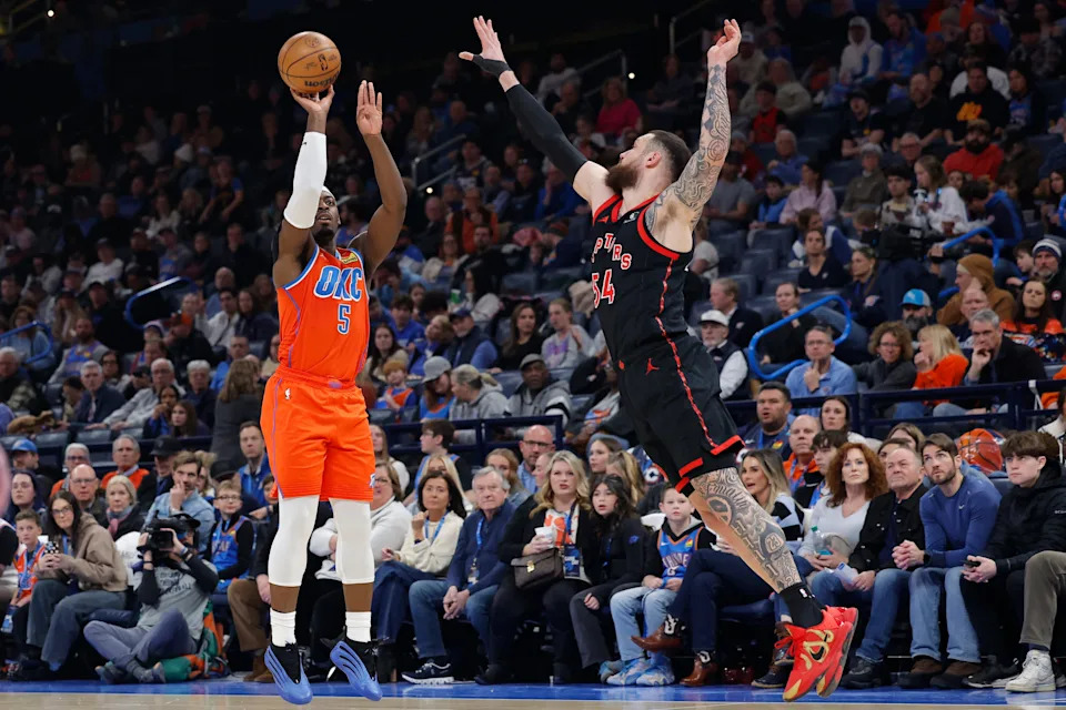 Jan 25, 2026; Oklahoma City, Oklahoma, USA; Oklahoma City Thunder guard Luguentz Dort (5) shoots a three point basket as Toronto Raptors forward/center Sandro Mamukelashvili (54) defends during the second quarter at Paycom Center. Mandatory Credit: Alonzo Adams-Imagn Images