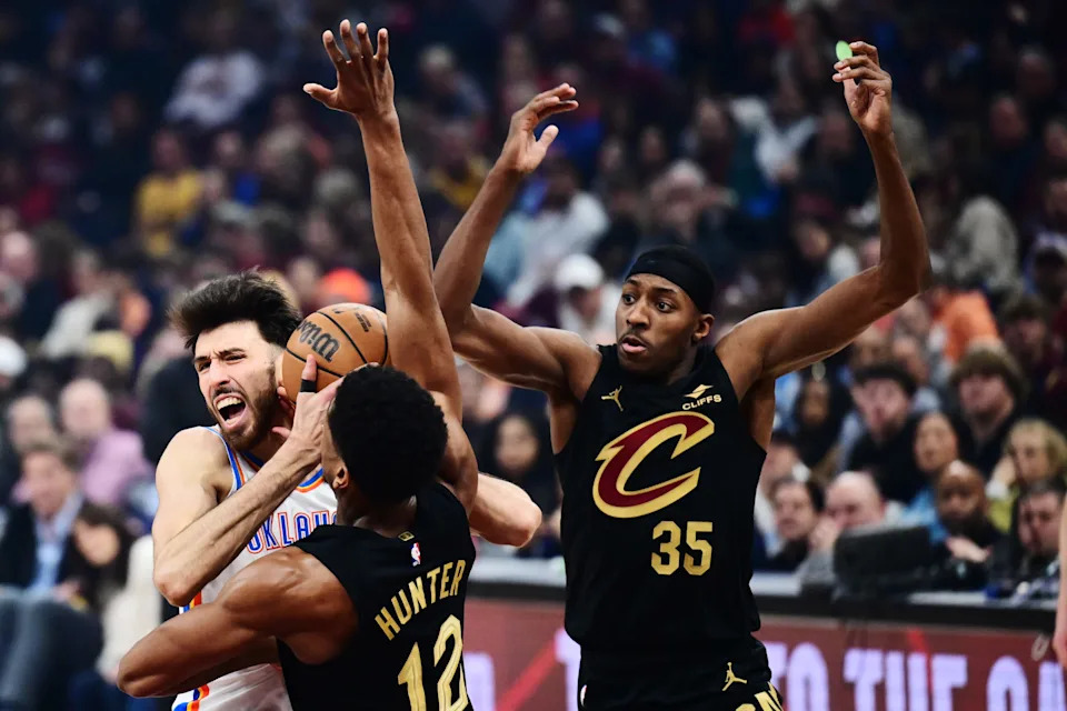 Jan 19, 2026; Cleveland, Ohio, USA; Oklahoma City Thunder center Chet Holmgren (7) drives to the basket against Cleveland Cavaliers forward Nae'qwan Tomlin (35) and forward De'andre Hunter (12) during the first half at Rocket Arena. Mandatory Credit: Ken Blaze-Imagn Images