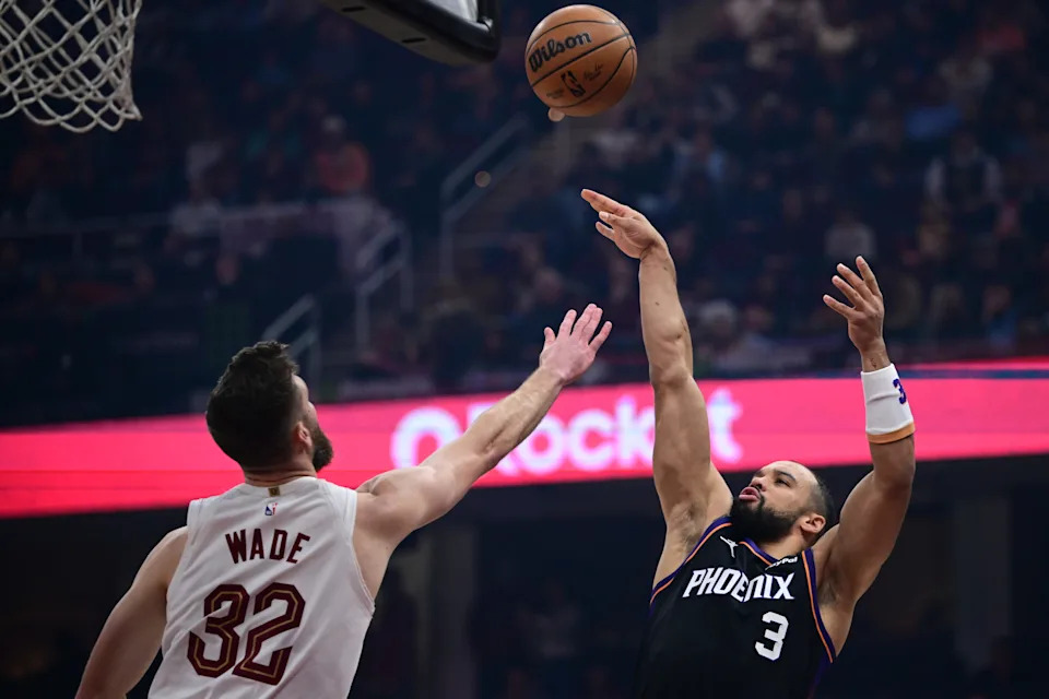 Dec 31, 2025; Cleveland, Ohio, USA; Phoenix Suns forward Dillon Brooks (3) shoots over Cleveland Cavaliers forward Dean Wade (32) during the first half at Rocket Arena. Mandatory Credit: David Dermer-Imagn Images