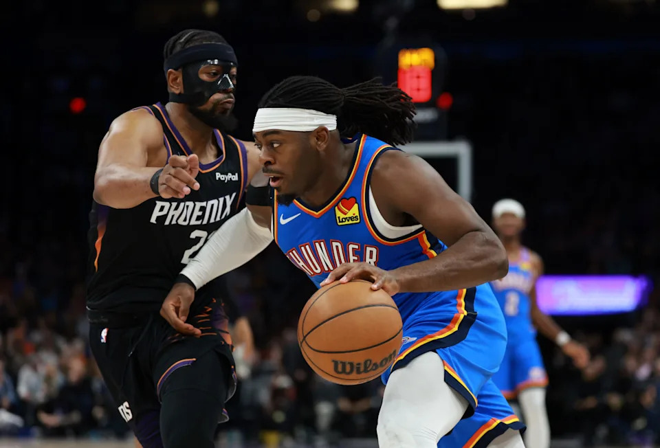 Jan 4, 2026; Phoenix, Arizona, USA; Phoenix Suns guard Jordan Goodwin (left) defends against Oklahoma City Thunder guard Luguentz Dort in the first half at Mortgage Matchup Center. Mandatory Credit: Mark J. Rebilas-Imagn Images