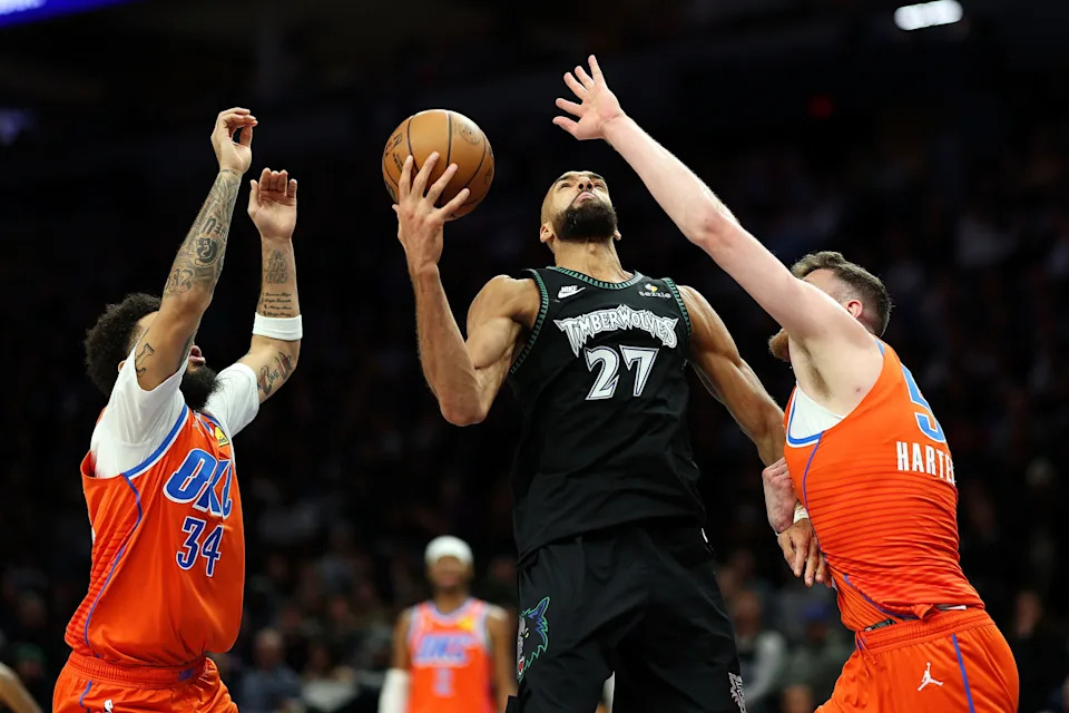 MINNEAPOLIS, MINNESOTA - JANUARY 29: Rudy Gobert #27 of the Minnesota Timberwolves rebounds the ball against Kenrich Williams #34 and Isaiah Hartenstein #55 of the Oklahoma City Thunder in the third quarter at Target Center on January 29, 2026 in Minneapolis, Minnesota. The Timberwolves defeated the Thunder 123-111. NOTE TO USER: User expressly acknowledges and agrees that, by downloading and or using this photograph, User is consenting to the terms and conditions of the Getty Images License Agreement. (Photo by David Berding/Getty Images)