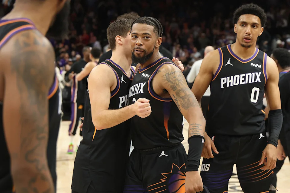 PHOENIX, ARIZONA - JANUARY 04: Jordan Goodwin #23 of the Phoenix Suns is congratulated by Collin Gillespie #12 and Ryan Dunn #0 after defeating the Oklahoma City Thunder in the NBA game at Mortgage Matchup Center on January 04, 2026 in Phoenix, Arizona. The Suns defeated the Thunder 108-105. NOTE TO USER: User expressly acknowledges and agrees that, by downloading and or using this photograph, user is consenting to the terms and conditions of the Getty Images License Agreement. (Photo by Christian Petersen/Getty Images)