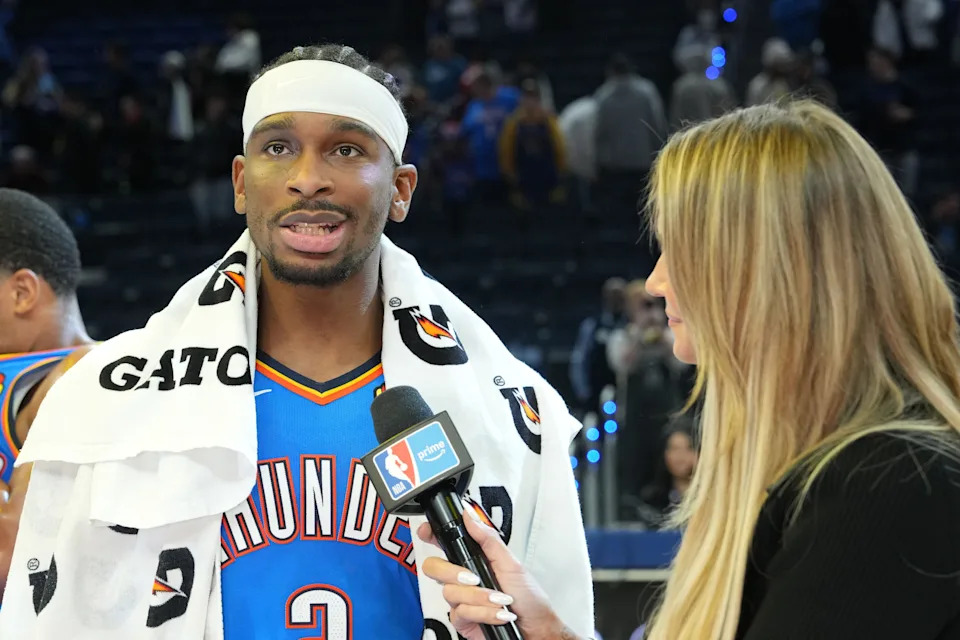 Jan 2, 2026; San Francisco, California, USA; Oklahoma City Thunder guard Shai Gilgeous-Alexander (left) is interviewed after defeating the Golden State Warriors at Chase Center. Mandatory Credit: Darren Yamashita-Imagn Images