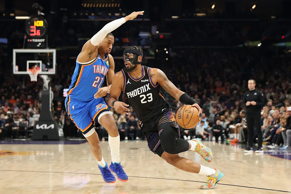 PHOENIX, ARIZONA - JANUARY 04: Jordan Goodwin #23 of the Phoenix Suns handles the ball against Aaron Wiggins #21 of the Oklahoma City Thunder during the first half of the NBA game at Mortgage Matchup Center on January 04, 2026 in Phoenix, Arizona. NOTE TO USER: User expressly acknowledges and agrees that, by downloading and or using this photograph, user is consenting to the terms and conditions of the Getty Images License Agreement. (Photo by Christian Petersen/Getty Images)