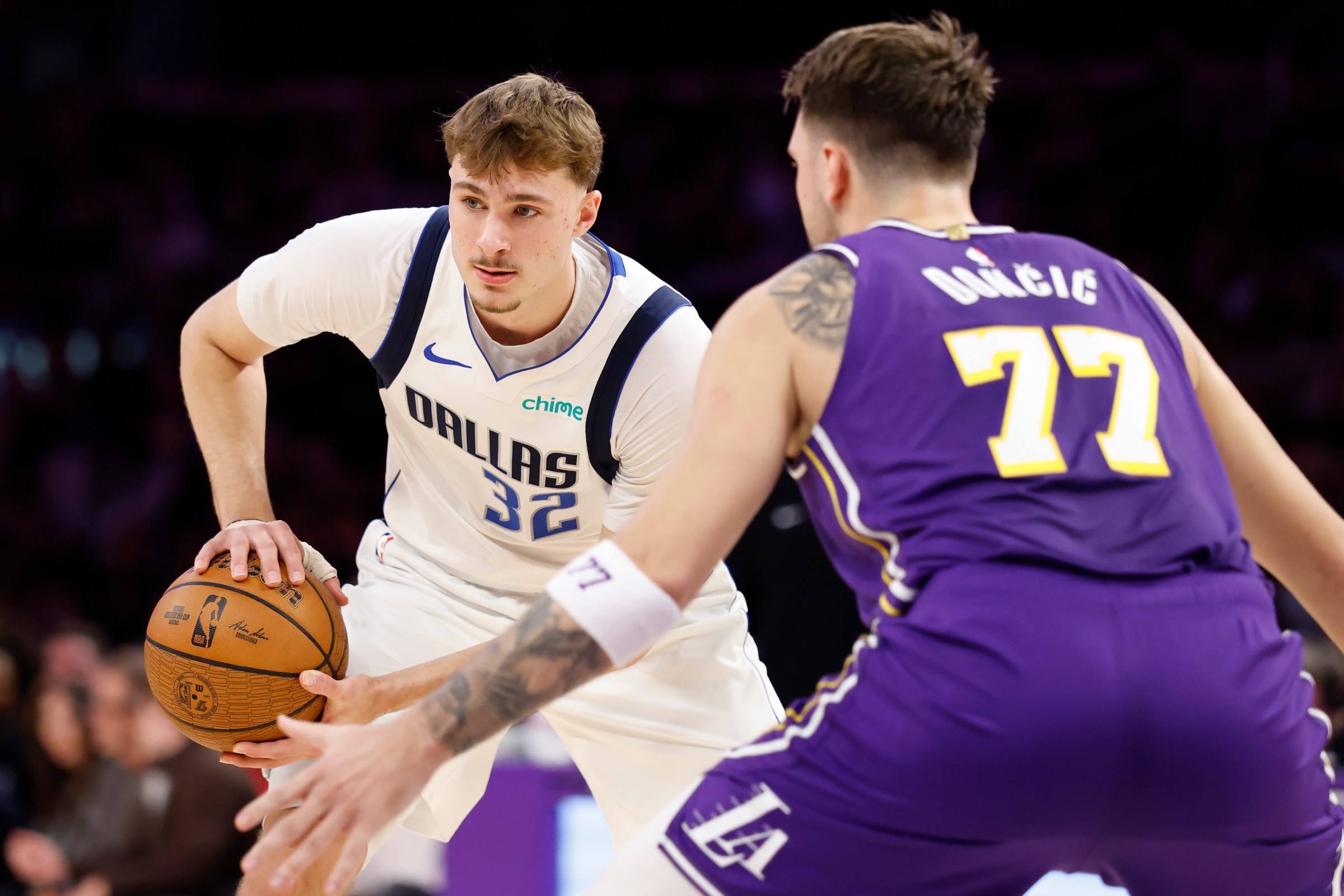 LOS ANGELES, CALIFORNIA - NOVEMBER 28: Cooper Flagg #32 of the Dallas Mavericks looks on as Luka Doncic #77 of the Los Angeles Lakers defends during the first quarter at Crypto.com Arena on November 28, 2025 in Los Angeles, California. NOTE TO USER: User expressly acknowledges and agrees that, by downloading and or using this photograph, User is consenting to the terms and conditions of the Getty Images License Agreement. (Photo by Ronald Martinez/Getty Images)