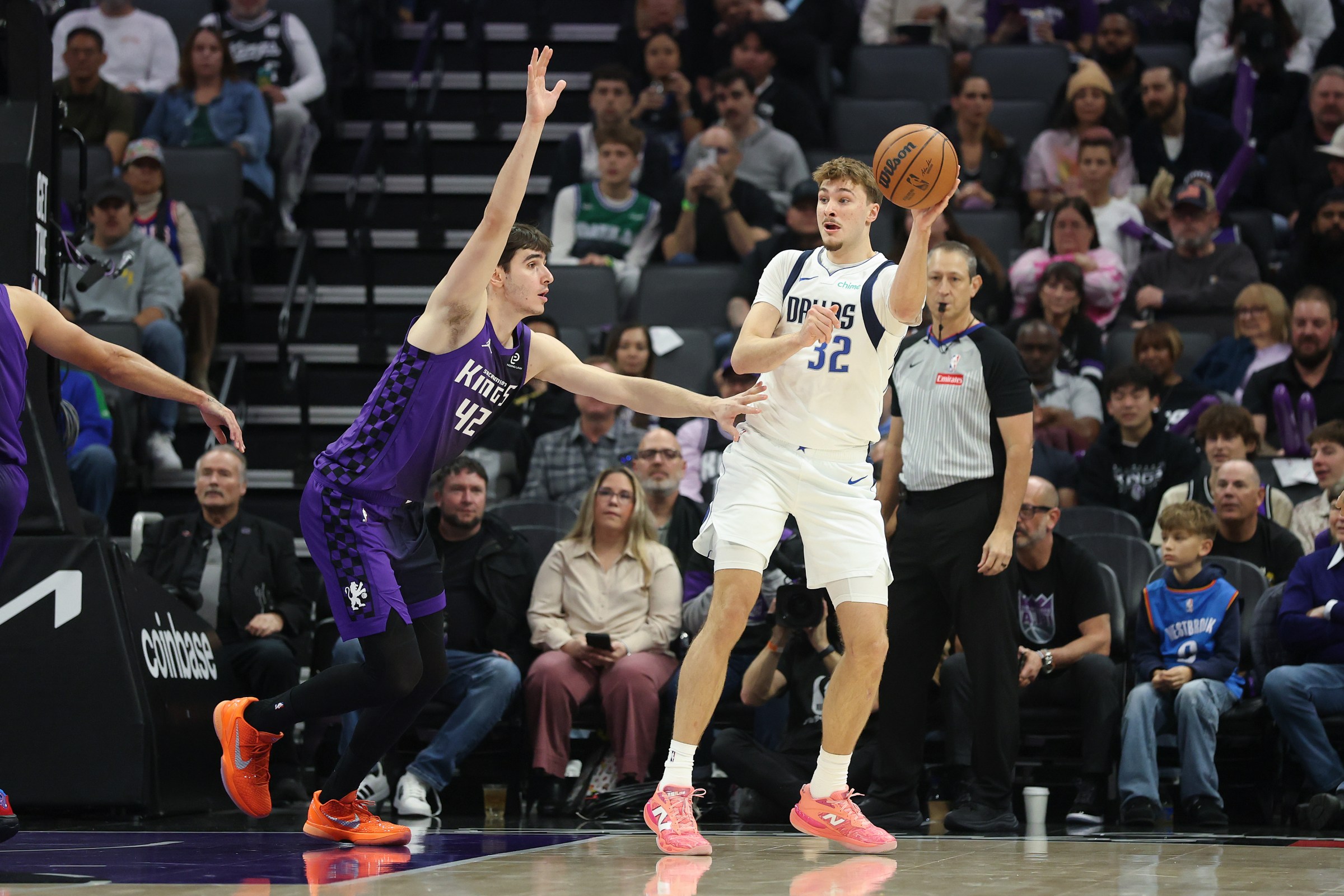 SACRAMENTO, CALIFORNIA - JANUARY 06: Cooper Flagg #32 of the Dallas Mavericks is guarded by Maxime Raynaud #42 of the Sacramento Kings during the first quarter at Golden 1 Center on January 06, 2026 in Sacramento, California. NOTE TO USER: User expressly acknowledges and agrees that, by downloading and/or using this photograph, user is consenting to the terms and conditions of the Getty Images License Agreement. (Photo by Ezra Shaw/Getty Images)