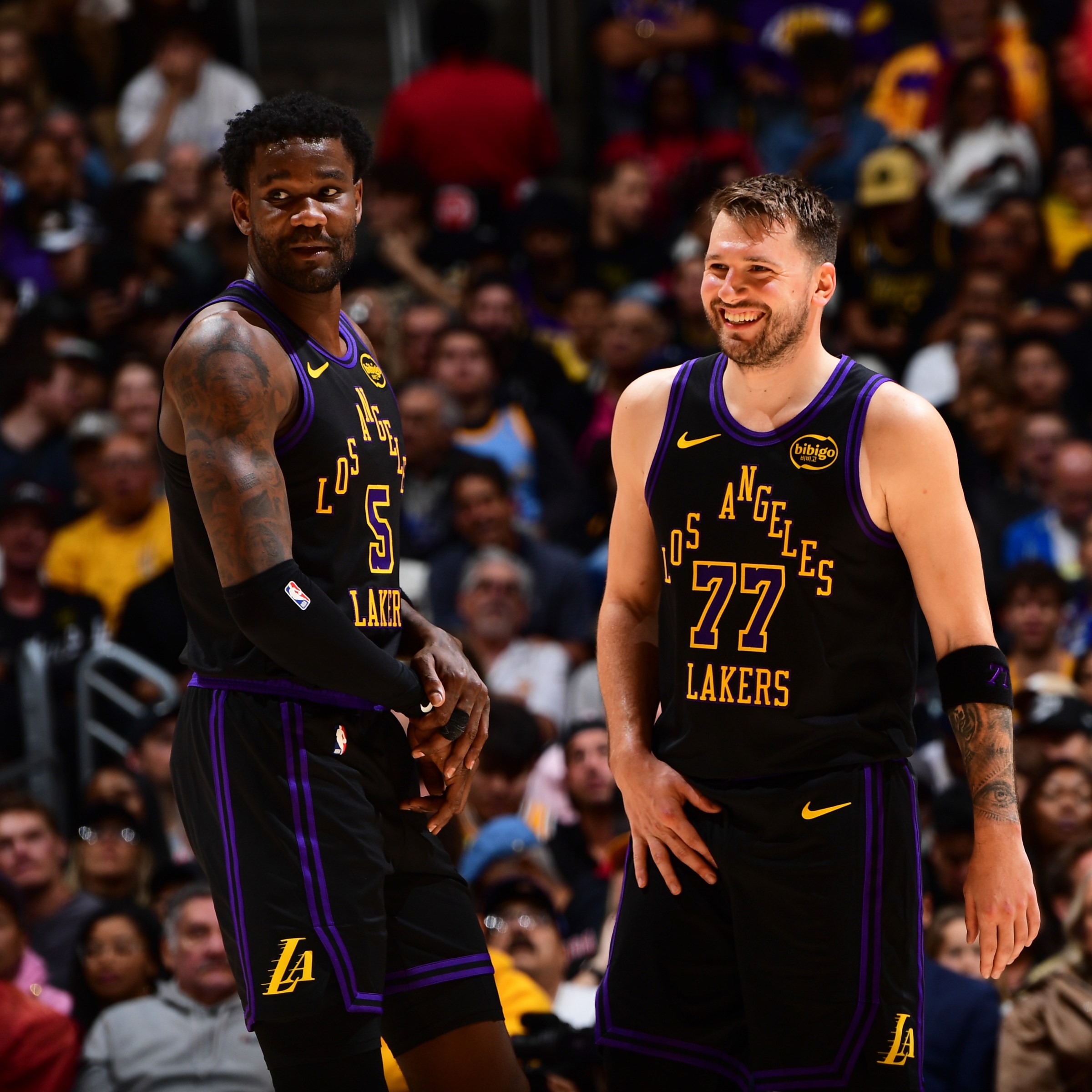 LOS ANGELES, CA - JANUARY 13: Deandre Ayton #5 and Luka Doncic #77 of the Los Angeles Lakers looks on during the game against the Atlanta Hawks on January 13, 2026 at Crypto.Com Arena in Los Angeles, California. NOTE TO USER: User expressly acknowledges and agrees that, by downloading and/or using this Photograph, user is consenting to the terms and conditions of the Getty Images License Agreement. Mandatory Copyright Notice: Copyright 2026 NBAE (Photo by Adam Pantozzi/NBAE via Getty Images)