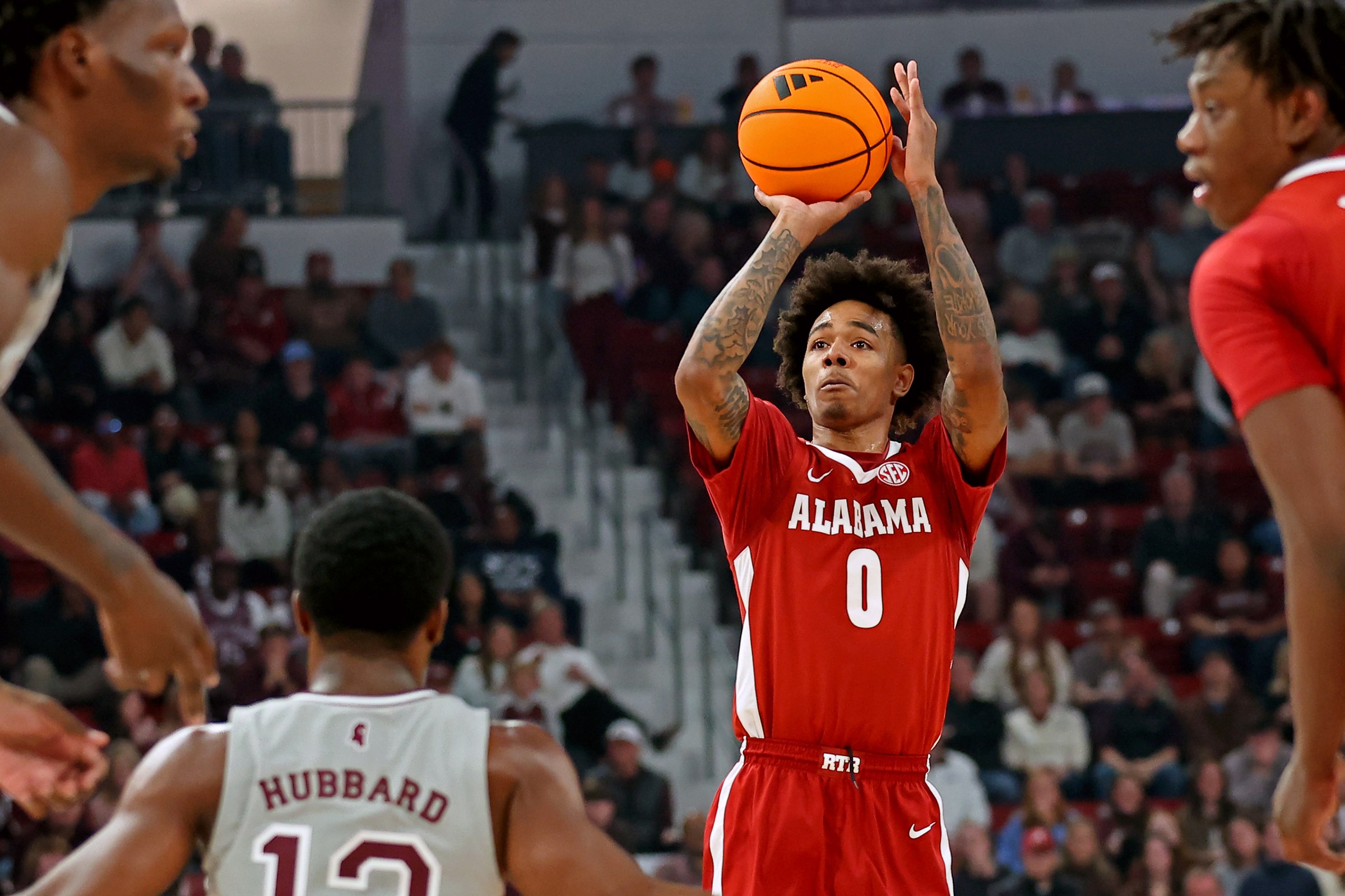 STARKVILLE, MISSISSIPPI - JANUARY 13: Labaron Philon Jr. #0 of the Alabama Crimson Tide shoots a three point basket over Josh Hubbard #12 of the Mississippi State Bulldogs during the first half at Humphrey Coliseum on January 13, 2026 in Starkville, Mississippi. (Photo by Jason Clark/Getty Images)