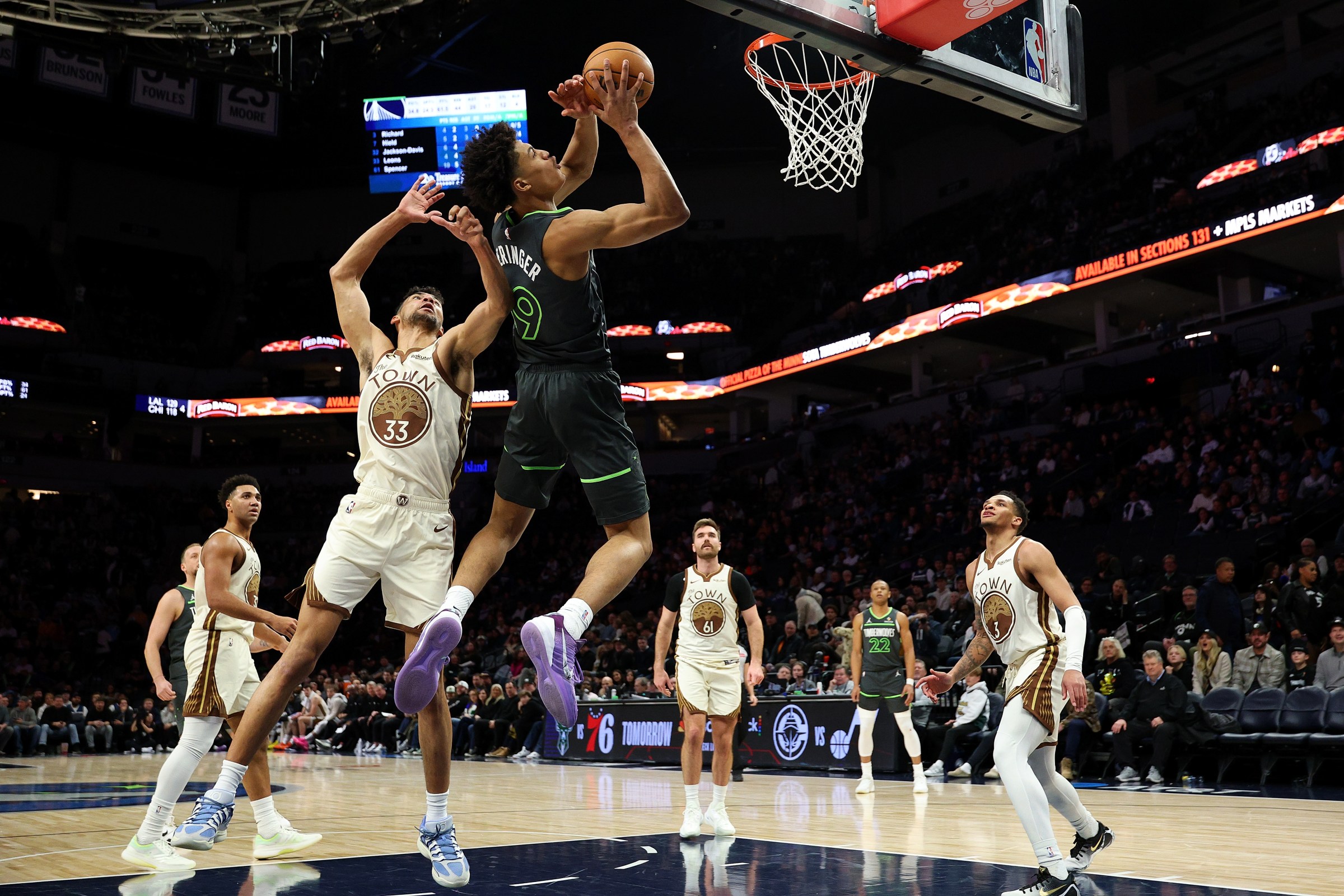 MINNEAPOLIS, MINNESOTA - JANUARY 26: Joan Beringer #19 of the Minnesota Timberwolves goes up for a shot past Malevy Leons #33 of the Golden State Warriors in the fourth quarter at Target Center on January 26, 2026 in Minneapolis, Minnesota. The Timberwolves defeated the Warriors 108-83. NOTE TO USER: User expressly acknowledges and agrees that, by downloading and or using this photograph, User is consenting to the terms and conditions of the Getty Images License Agreement. (Photo by David Berding/Getty Images)