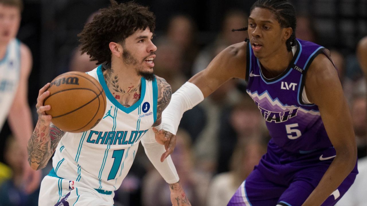 Charlotte Hornets guard LaMelo Ball (1) looks to pass the ball as Utah Jazz forward Cody Williams (5) defends during the first half of an NBA basketball game, Saturday, Jan. 10, 2026, in Salt Lake City. (AP Photo/Bethany Baker)