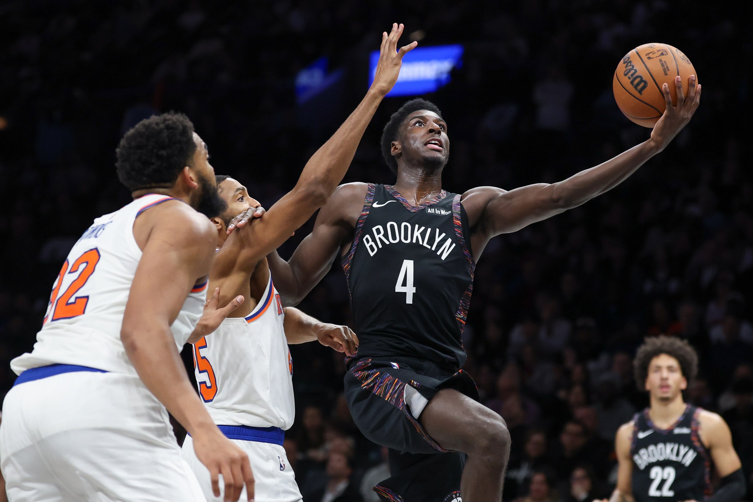 Nov 24, 2025; Brooklyn, New York, USA; Brooklyn Nets guard Drake Powell (4) goes to the basket as New York Knicks guard Mikal Bridges (25) defends during the second half at Barclays Center. Mandatory Credit: Vincent Carchietta-Imagn Images