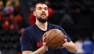 Ivica Zubac holding a basketball