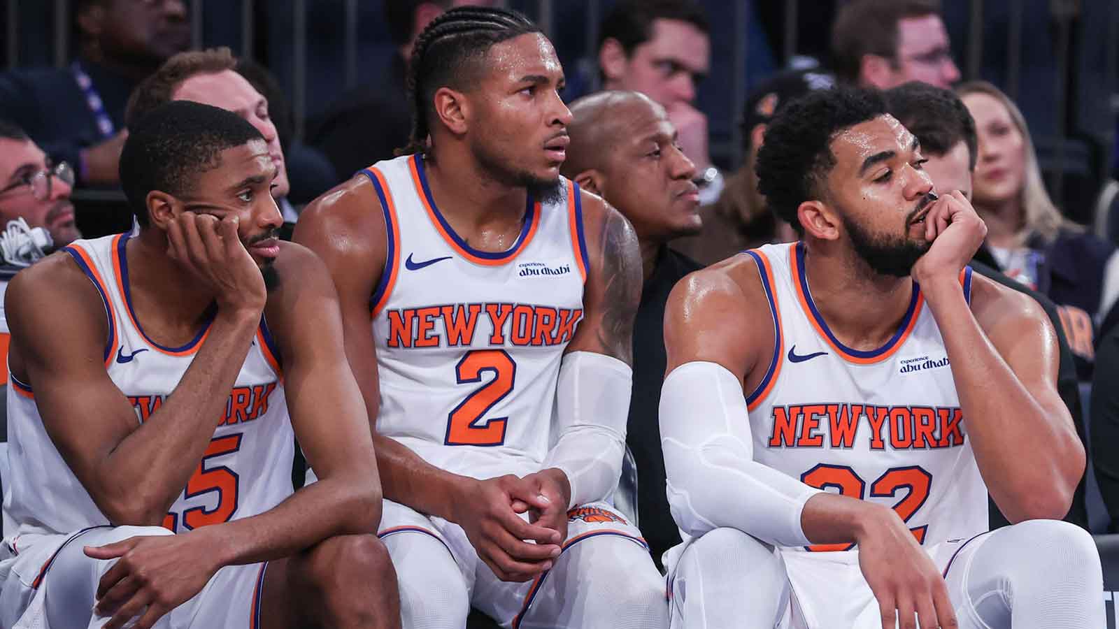 Nov 12, 2025; New York, New York, USA; New York Knicks guards Mikal Bridges (25), Miles McBride (2), and center Karl-Anthony Towns (32) watch from the bench in the fourth quarter against the Orlando Magic at Madison Square Garden. Mandatory Credit: Wendell Cruz - Imagn Images