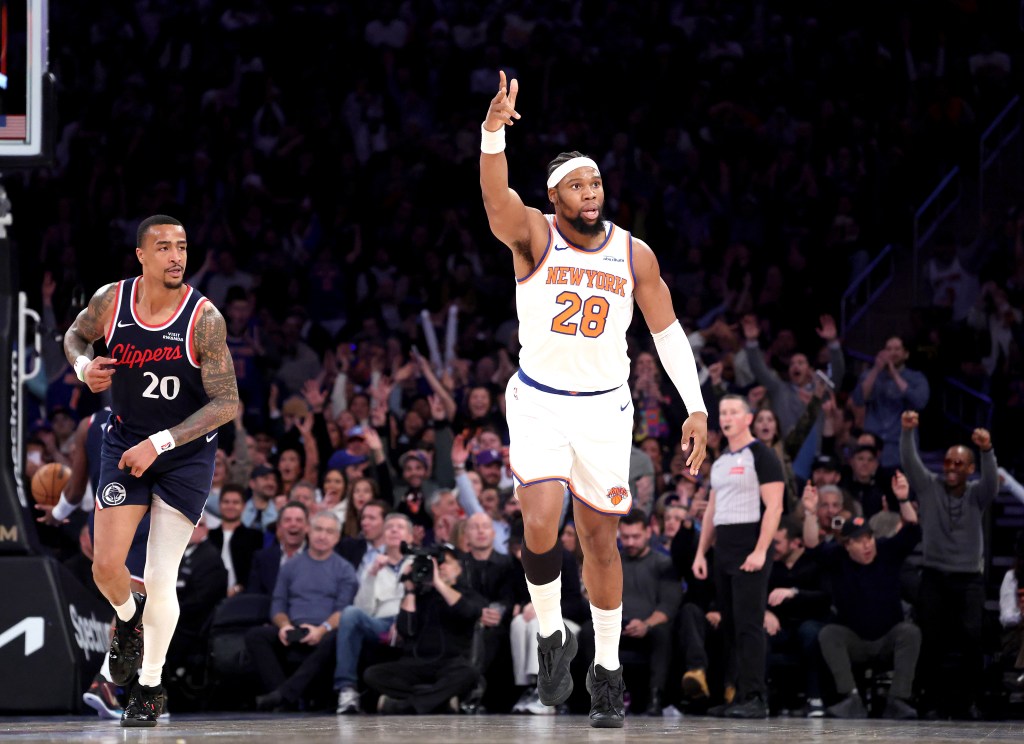 New York Knicks forward Guerschon Yabusele #28 reacts after he hits a three-point shot over LA Clippers forward John Collins #20 during the fourth quarter. 