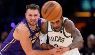 Los Angeles Lakers guard Luka Doncic, left, and Milwaukee Bucks guard Kevin Porter Jr. go after a loose ball during the first half of an NBA basketball game Friday, Jan. 9, 2026, in Los Angeles. (AP Photo/Mark J. Terrill)