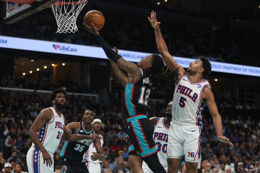 Memphis Grizzlies guard Ja Morant (12) shoots as Philadelphia 76ers guard Quentin Grimes (5) defends.