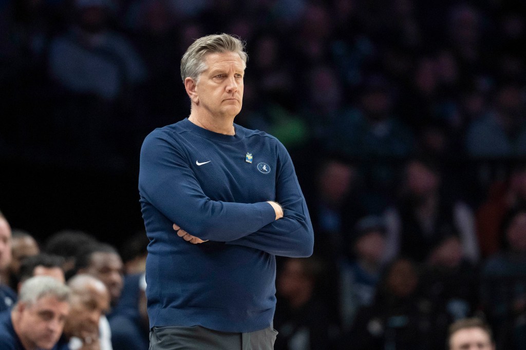 Minnesota Timberwolves head coach Chris Finch watches the game from the sidelines.
