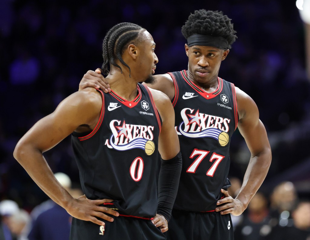 Philadelphia 76ers guard Tyrese Maxey (0) and guard Vj Edgecombe (77) talk during a break in the game.
