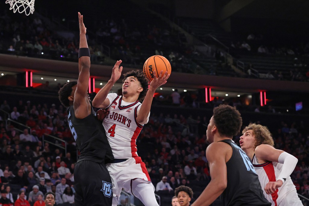 St. John's Red Storm guard Oziyah Sellers #4 goes up for a shot as Marquette Golden Eagles guard Tre Norman #5 defends.