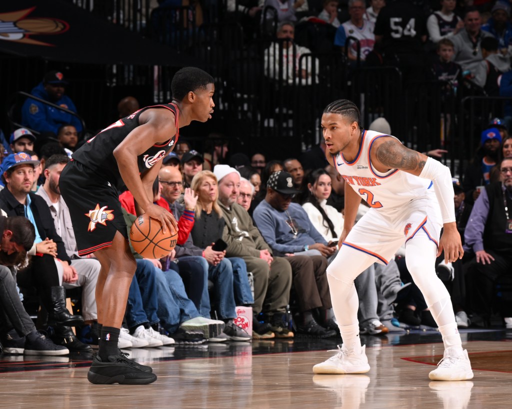 Miles McBride #2 of the New York Knicks defends VJ Edgecombe #77 of the Philadelphia 76ers during the Saturday game.