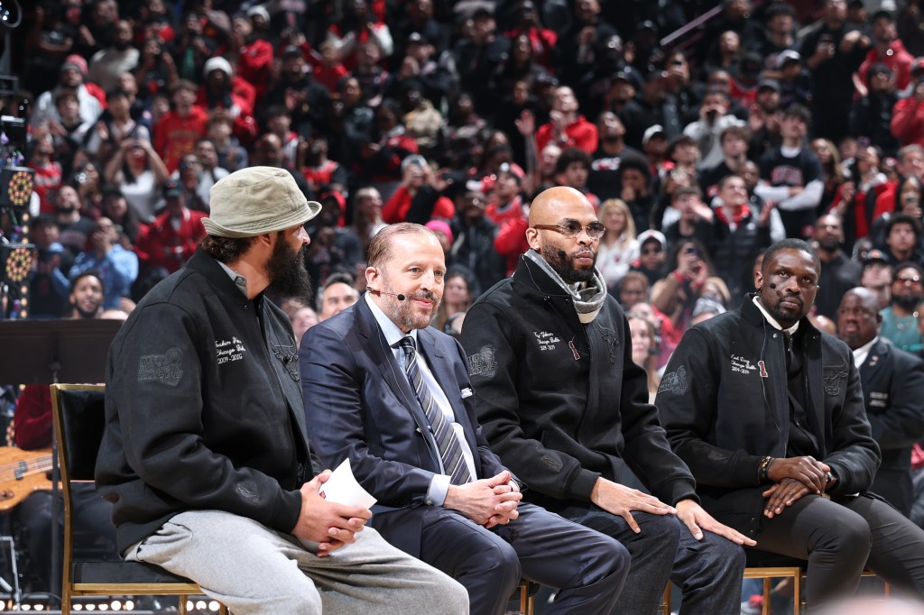Joakim Noah, Tom Thibodeau, Taj Gibson, and Luol Deng watching the Derrick Rose jersey retirement.