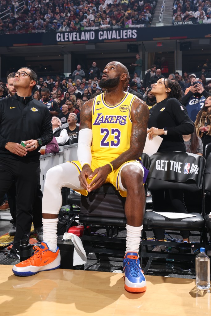 LeBron James of the Los Angeles Lakers sits on the bench and looks up before a game against the Cleveland Cavaliers.
