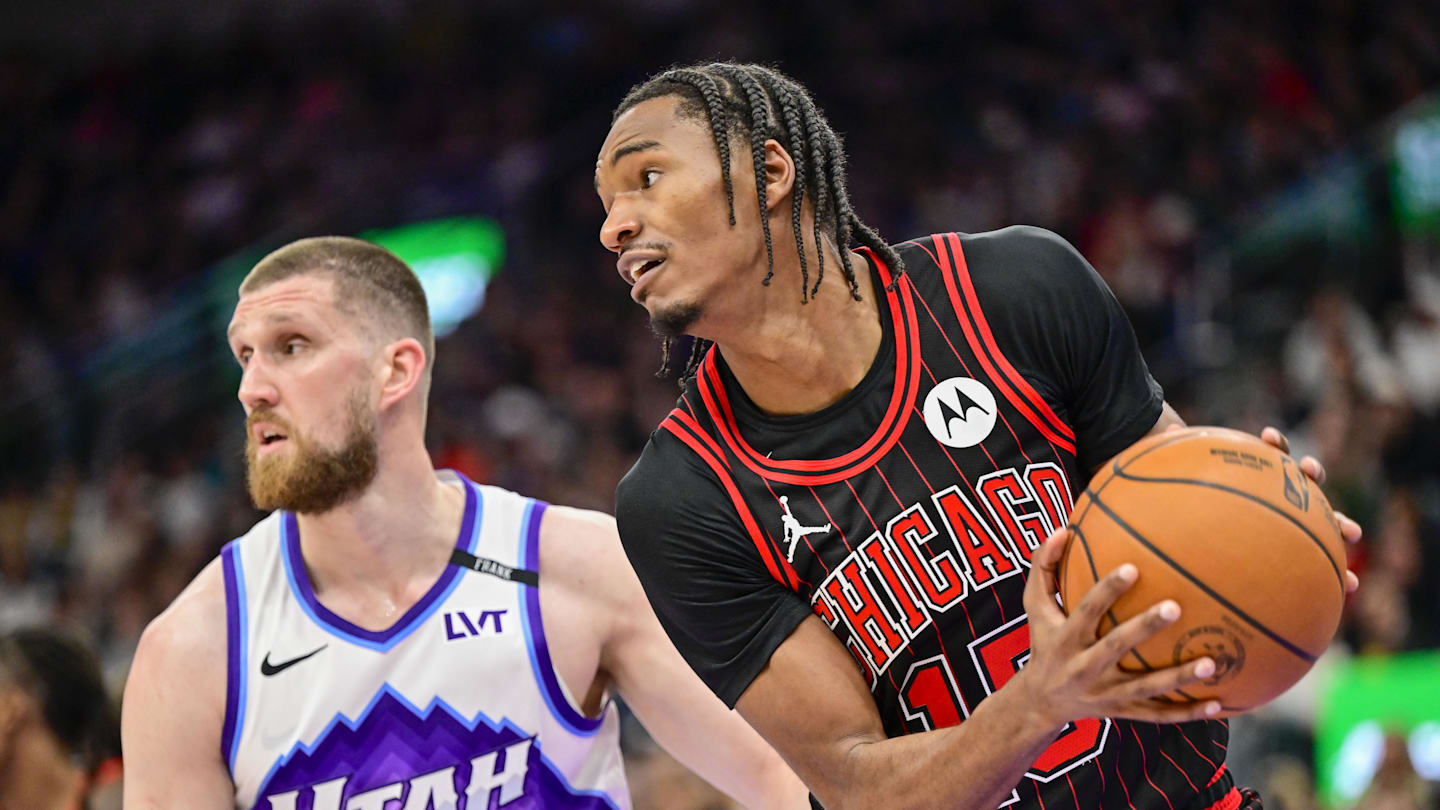 Nov 16, 2025; Salt Lake City, Utah, USA; Chicago Bulls forward Julian Phillips (15) makes a rebound against Utah Jazz guard/forward Svi Mykhailiuk (10) during the first half at Delta Center. Mandatory Credit: Peter Creveling-Imagn Images