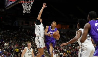 Jul 14, 2025; Las Vegas, NV, USA;  Utah Jazz forward John Tonje (17) drives towards the basket against San Antonio Spurs forward Carter Bryant (11) during the first half of a NBA basketball game at the Thomas & Mack Center. Mandatory Credit: Lucas Peltier-Imagn Images