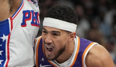 Feb 7, 2026; Phoenix, Arizona, USA; Phoenix Suns guard Devin Booker (1) drives on Philadelphia 76ers guard Kelly Oubre Jr. (9) during the first half of an NBA game at Mortgage Matchup Center. Mandatory Credit: Rick Scuteri-Imagn Images