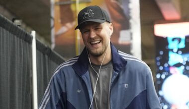 Atlanta Hawks player Kristaps Porzingis and head coach Quin Snyder share laughs while entering Frost Bank Center before a game against the San Antonio Spurs