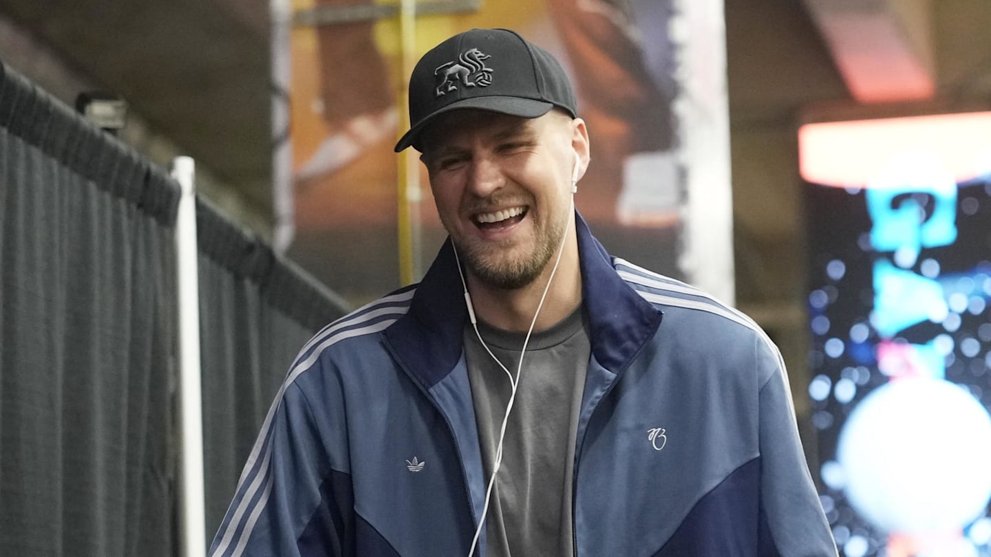 Atlanta Hawks player Kristaps Porzingis and head coach Quin Snyder share laughs while entering Frost Bank Center before a game against the San Antonio Spurs
