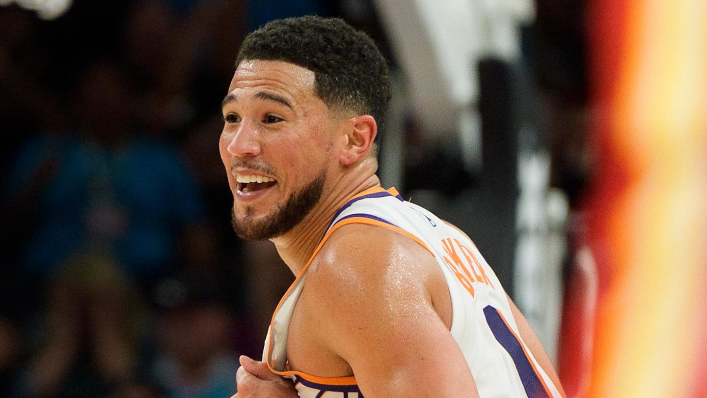 Phoenix Suns guard Devin Booker reacts and smiles during the second half of play against the Atlanta Hawks at Mortgage Matchup Center.