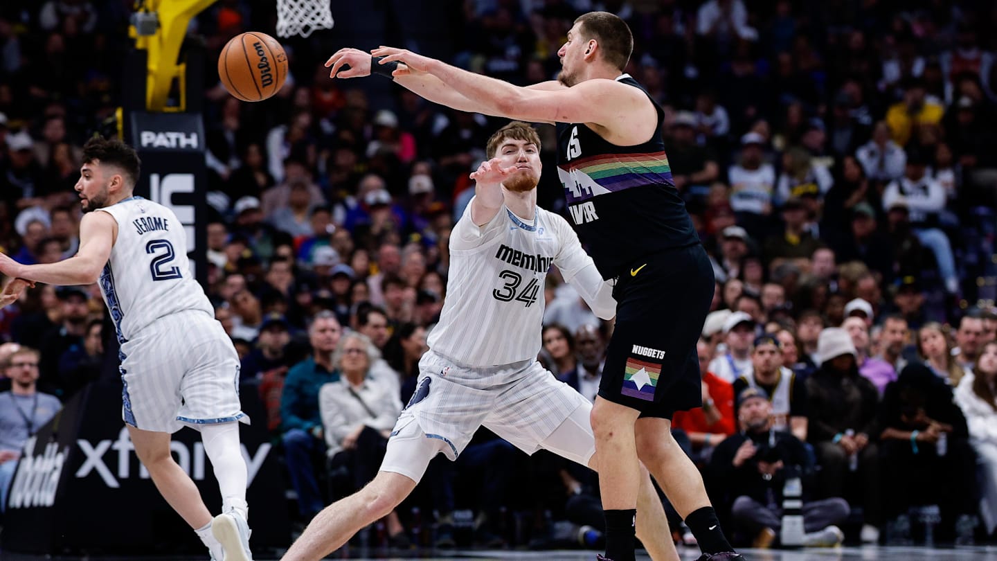 Feb 11, 2026; Denver, Colorado, USA; Denver Nuggets center Nikola Jokic (15) passes the ball as Memphis Grizzlies center Lawson Lovering (34) defends in the fourth quarter at Ball Arena. Mandatory Credit: Isaiah J. Downing-Imagn Images