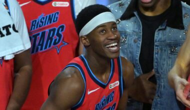 Feb 13, 2026; Inglewood, California, USA; Team Vince guard VJ Edgecombe (77) of the Philadelphia 76ers reacts with the MVP trophy after defeating Team Melo during an NBA All Star Rising Stars championship game at Intuit Dome. Mandatory Credit: Jayne Kamin-Oncea-Imagn Images