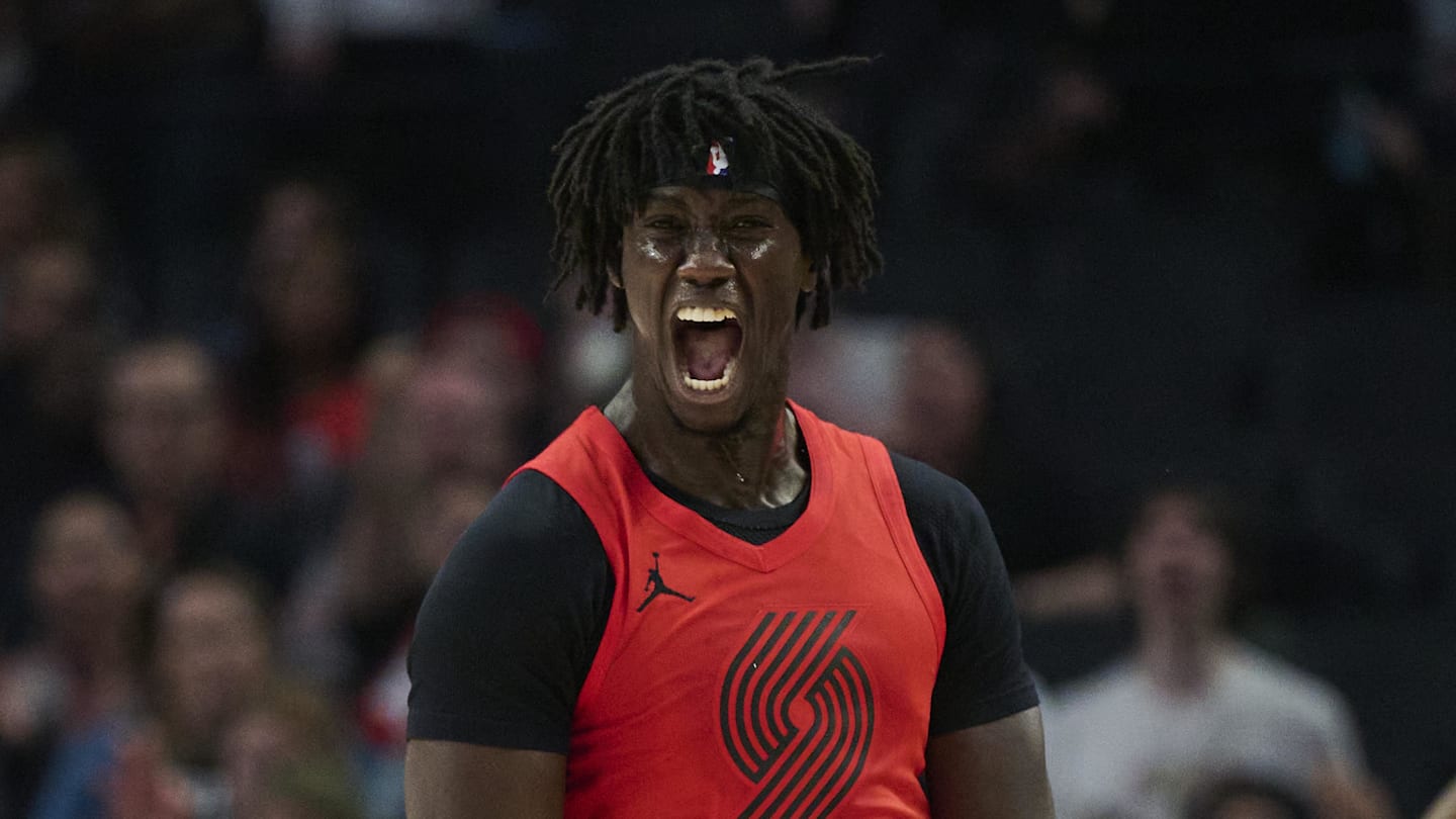 Jan 9, 2026; Portland, Oregon, USA; Portland Trail Blazers guard Sidy Cissoko (91) celebrates after scoring a three point basket during the first half against Houston Rockets forward Jabari Smith Jr. (10) at Moda Center. Mandatory Credit: Troy Wayrynen-Imagn Images