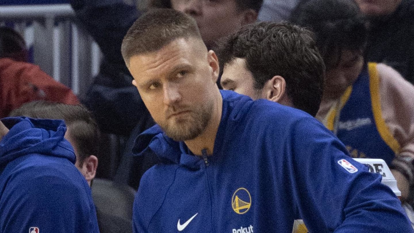 Feb 19, 2026; San Francisco, California, USA; New Golden State Warriors forward Kristaps Porzingis (with towel) watches the action against the Boston Celtics from the bench during the first quarter at Chase Center. Mandatory Credit: D. Ross Cameron-Imagn Images
