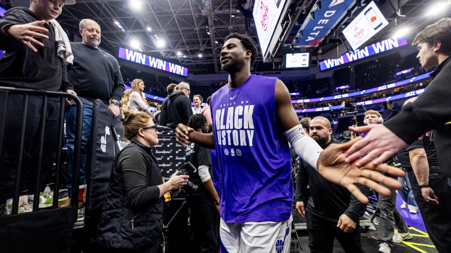 Utah Jazz forward Jaren Jackson Jr. slaps hands with fans...