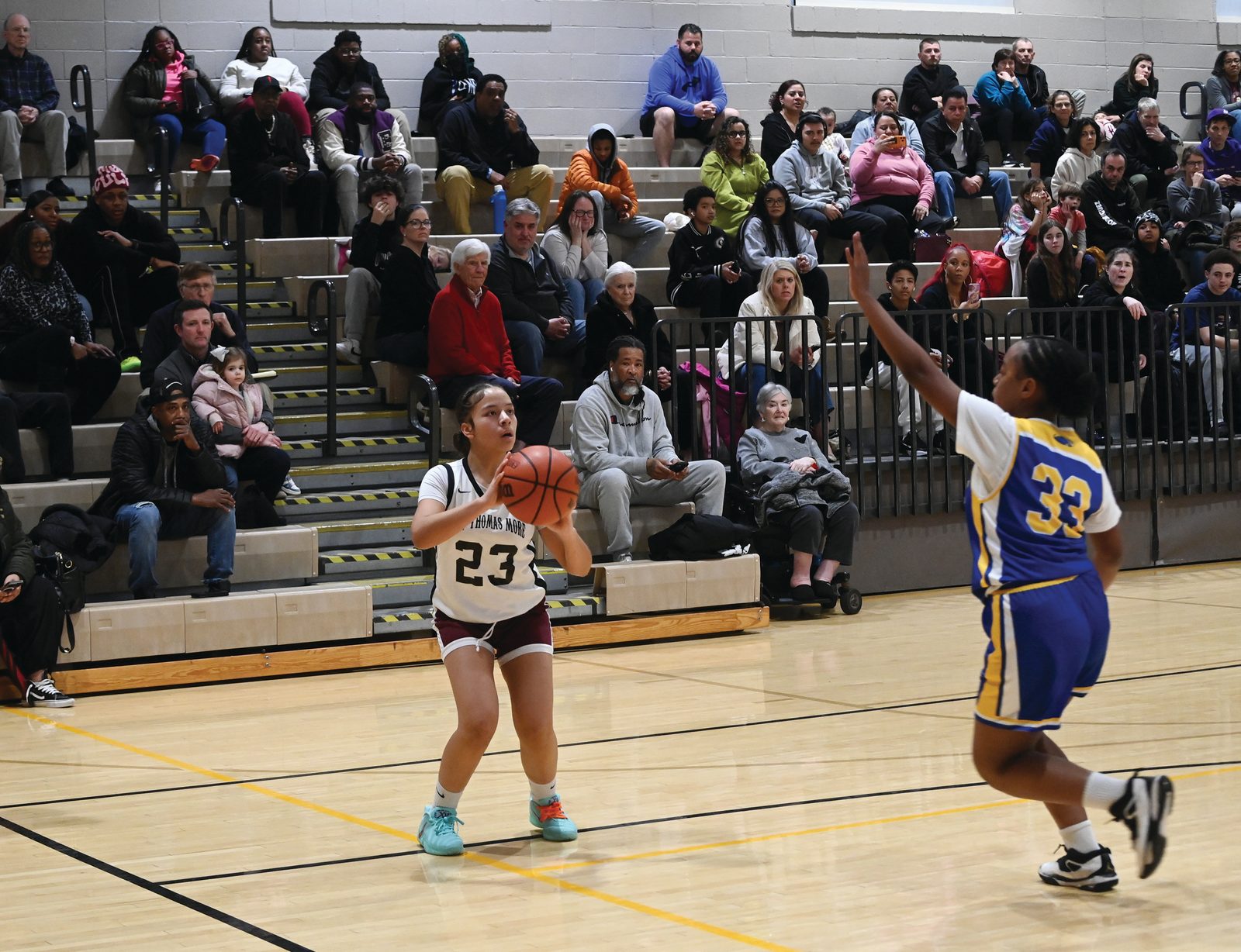 Ashley Hose  (#23) from St. Thomas More takes a shot while being defended by Mullyrana Durce (#33) of St. Jerome’s during the CYO girls’ 14U basketball championship game on Feb. 15 at Georgetown Visitation that was won by St. Thomas More, 34-26. (Catholic Standard photo by Patrick Ryan)