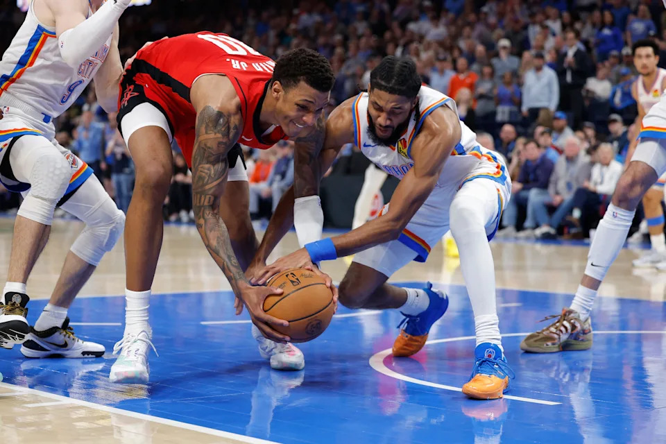 Feb 7, 2026; Oklahoma City, Oklahoma, USA; Houston Rockets forward Jabari Smith Jr. (10) and Oklahoma City Thunder guard Isaiah Joe (11) fight for a loose ball during the second half at Paycom Center. Mandatory Credit: Alonzo Adams-Imagn Images