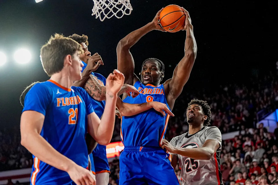 Feb 11, 2026; Athens, Georgia, USA; Florida Gators center Rueben Chinyelu (9) grabs a rebound over Georgia Bulldogs forward Justin Abson (25) during the first half at Stegeman Coliseum. Mandatory Credit: Dale Zanine-Imagn Images