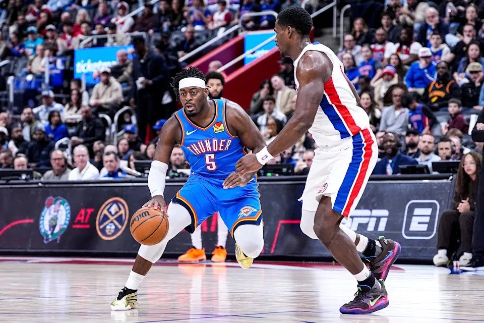 Oklahoma City Thunder guard Luguentz Dort (5) dribbles against Detroit Pistons center Jalen Duren (0) during the second half at Little Caesars Arena in Detroit on Wednesday, Feb. 25, 2026.