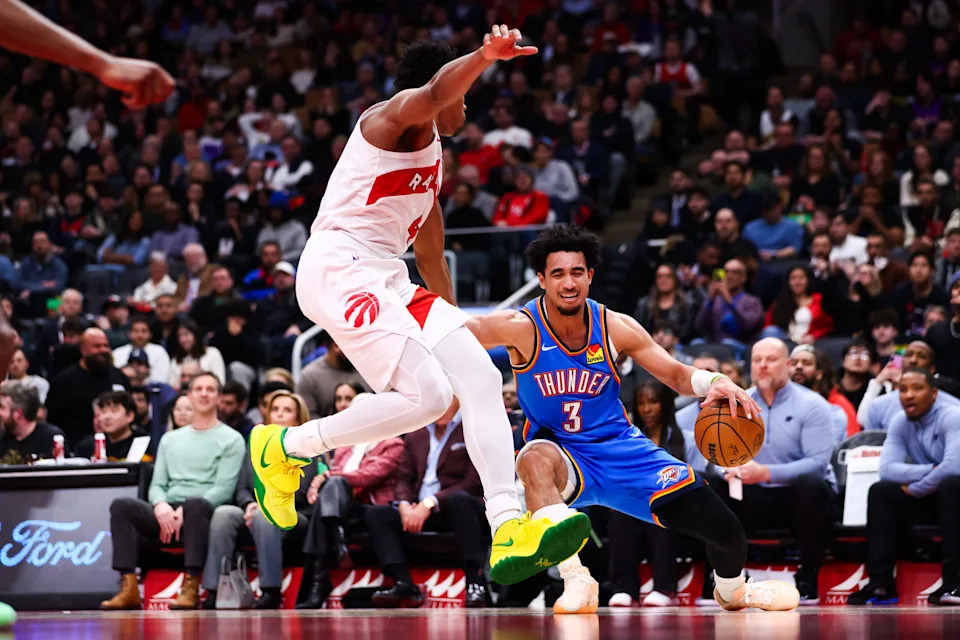 TORONTO, CANADA - FEBRUARY 24: Jared McCain #3 of the Oklahoma City Thunder dribbles against Scottie Barnes #4 of the Toronto Raptors during the second half of their NBA game at Scotiabank Arena on February 24, 2026 in Toronto, Ontario, Canada. NOTE TO USER: User expressly acknowledges and agrees that, by downloading and or using this photograph, User is consenting to the terms and conditions of the Getty Images License Agreement. (Photo by Cole Burston/Getty Images)