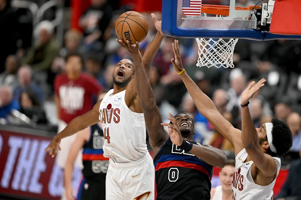 Pistons center Jalen Duren drives to the basket between Cleveland Cavaliers forward Evan Mobley (4) and center Jarrett Allen on Feb. 27, 2026, in Detroit.