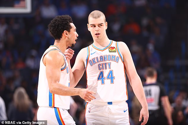The player talks to Thunder teammate Jared McCain during the game against the Bucks