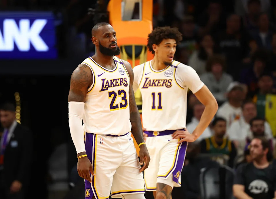 Los Angeles Lakers forward LeBron James (23) and center Jaxson Hayes (11) look on during a game.© Mark J&period; Rebilas-Imagn Images