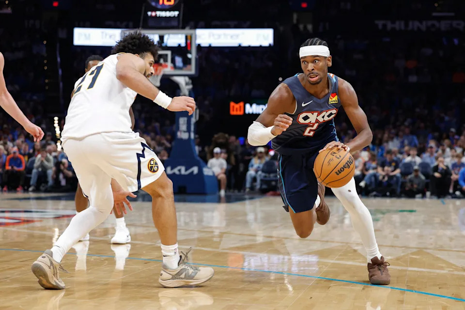 Feb 27, 2026; Oklahoma City, Oklahoma, USA; Oklahoma City Thunder guard Shai Gilgeous-Alexander (2) moves the ball around Denver Nuggets guard Jamal Murray (27) during the third quarter at Paycom Center. Mandatory Credit: Alonzo Adams-Imagn Images