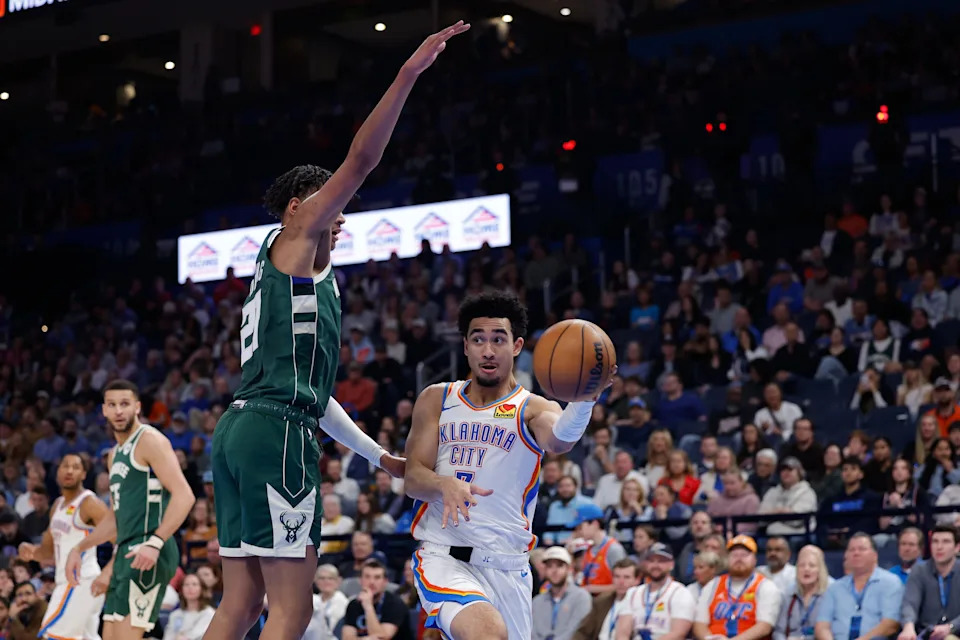 Feb 12, 2026; Oklahoma City, Oklahoma, USA; Oklahoma City Thunder guard Jared McCain (3) passes around Milwaukee Bucks forward Ousmane Dieng (21) during the second half at Paycom Center. Mandatory Credit: Alonzo Adams-Imagn Images