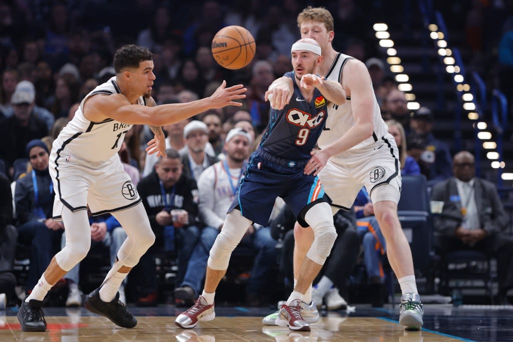 Alex Caruso (9) passes as Michael Porter Jr. (17) defends during the first half of the Nets’ 105-86 loss to the Thunder at Paycom Center on Feb. 20, 2026 in Oklahoma City. IMAGN IMAGES via Reuters Connect