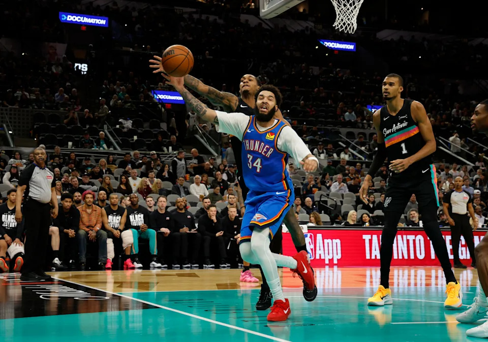 SAN ANTONIO, TX - FEBRUARY 4: Devin Vassell #24 of the San Antonio Spurs reaches over Kenrich Williams #34 of the Oklahoma City Thunder for a loose ball in the second half at Frost Bank Center on February 1, 2026 in San Antonio, Texas. NOTE TO USER: User expressly acknowledges and agrees that, by downloading and or using this photograph, User is consenting to terms and conditions of the Getty Images License Agreement. (Photo by Ronald Cortes/Getty Images)