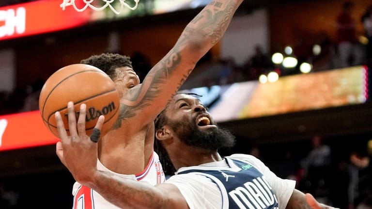 Dallas Mavericks forward Naji Marshall, right, shoots as Houston Rockets...